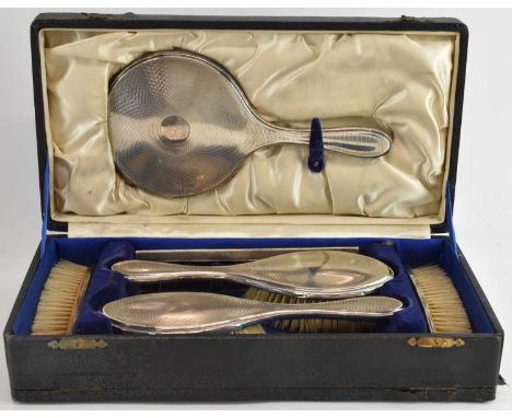 HASSETT &amp; HARPER LTD; a cased George V hallmarked silver six piece dressing table set, comprising two hand brushes, two f