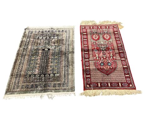 A Tunisian silk hand woven red ground prayer mat, 110 x 53cm, and a further Tunisian silk prayer mat, 110 x 68cm (2).