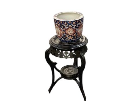 A late 19th century Japanese Imari decorated porcelain jardinière, height 21.5cm, diameter 25cm, raised on an early 20th cent
