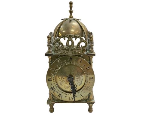 A small late 19th century brass domed bell topped mantel clock, the brass dial set with Roman numerals and subsidiary seconds