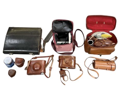 A collection of vintage camera lenses and camera equipment, including Polaroid Agfa Super Silette, Whatman Wrayflex, Polaroid