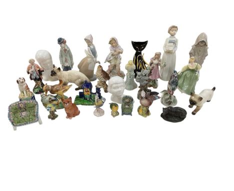 A collection of approximately twenty-five assorted ceramic figures and ornaments, including three Nao figures, one of young g