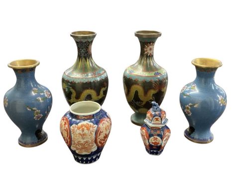 A pair of Chinese gilt metal black ground cloisonné enamel baluster form vases, both decorated with yellow five clawed dragon