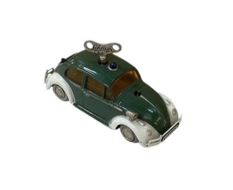 A Schuco 'Varianto 3040' green painted clockwork model vehicle, modelled as a Volkswagen Beetle, length approx 10cm.
