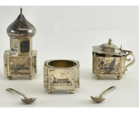 An Indian white metal and niello work three piece cruet comprising open salt, mustard and pepperette, and two associated niel