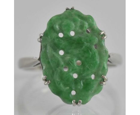 An 18ct white gold ring, with claw set carved jade tablet length 1.6cm, size H, approx 2.6g.