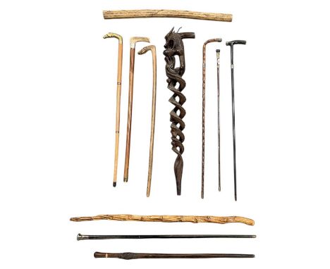 A collection of eleven assorted walking sticks and canes, including three silver topped examples, one hallmarked for London 1