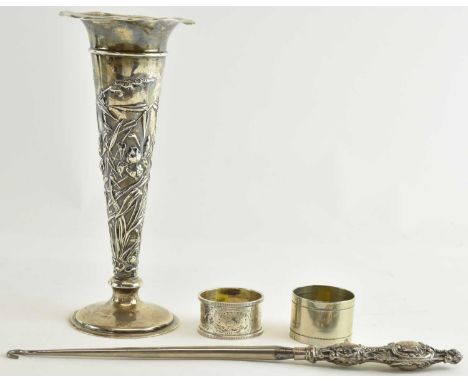 An early 20th century hallmarked silver trumpet shaped vase, with wavy rim and wheatgrass decoration, on loaded base, height 