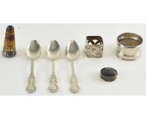 J STOCKMAN; a set of three white metal teaspoons, a circular white metal napkin ring, a square white metal napkin ring, a whi