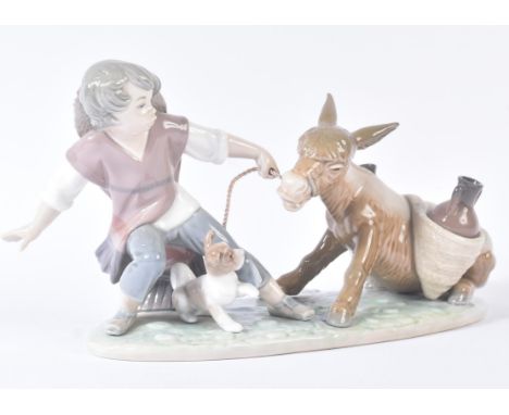 Lladro –&nbsp;Boy Pulling Donkey - H7 - ceramic figure / figurine modelled as a boy with a stubborn donkey.&nbsp; Modelled by