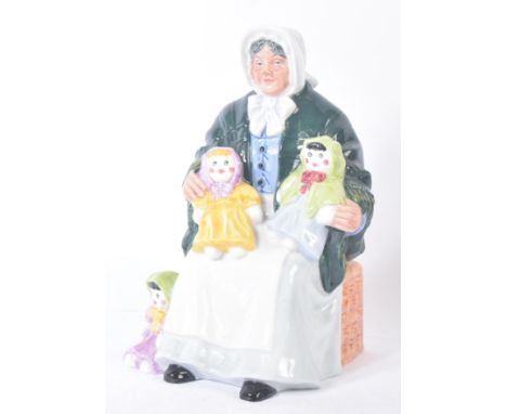 Royal Doulton – The Rag Doll Seller – HN2944 – a hand painted ceramic figure / figurine of an elderly lady with dolls. Maker’