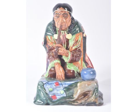 Royal Doulton – Calumet - HN1689 - a hand painted ceramic figure / figurine of a seated native American Indian smoking a pipe