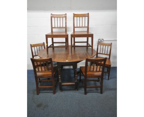 AN OAK BARLEY TWIST DROP LEAF TABLE, width 110cm x depth 49cm x height 76cm, and a set of six oak stick back chairs (scuffs a