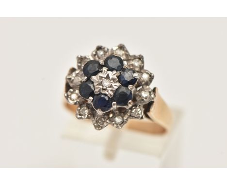 A 9CT GOLD SAPPHIRE AND DIAMOND CLUSTER RING, raised cluster set with a central illusion set single cut diamond, in a surroun
