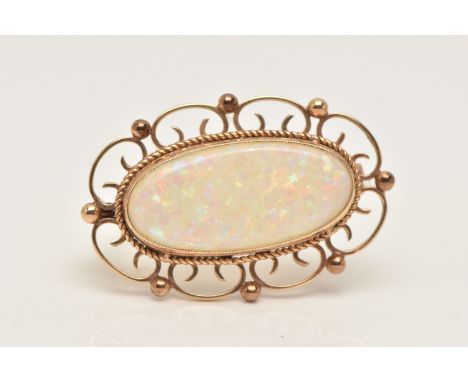 A 9CT GOLD SYNTHECTIC OPAL BROOCH, of an oval form, set with a synthetic opal cabochon, milgrain collet set with a fine rope 