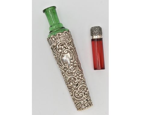 TWO SCENT BOTTLES, the first a green tapering glass bottle with embossed scrolling cover and engraved monogram, missing stopp