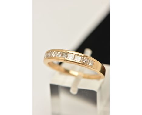 AN 18CT DIAMOND BAND RING, nine princess cut diamonds, channel set in yellow gold, estimated total diamond weight 0.70ct, cla