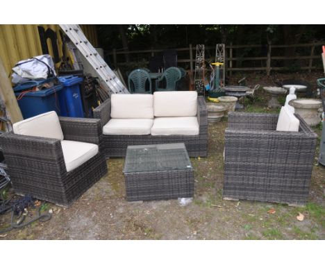 A RATTAN EFFECT GARDEN SUITE consisting of a 144cm wide sofa, two arm chairs and a square centre table ( Condition Report som
