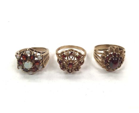 9ct gold opal and garent cluster ring and two other 9ct gold garnet cluster rings (3)Total weight 13.9 grams 