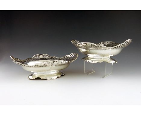 A pair of silver bonbon baskets, by Roberts and Dore Limited, Sheffield 1930, shaped oval form, pierced foliate scroll decora