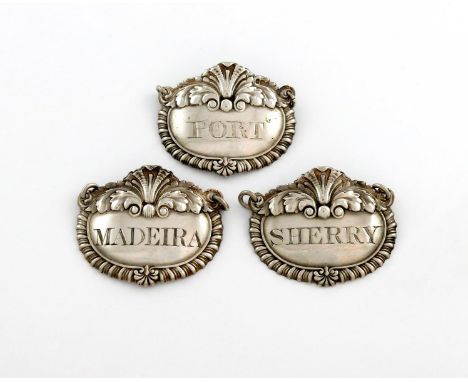 A matched set of three George III silver wine labels, by Paul Storr, London 1816 and 1817, shaped oval form, gadroon border w