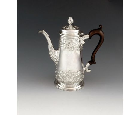 A George II silver coffee pot, by John Kincaid, London 1744, tapering circular form, chased foliate scroll decoration, scroll
