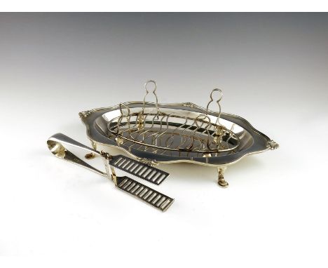 A silver asparagus dish, strainer and tongs, by the Goldsmiths and Silversmiths Company, London 1906 and Sheffield 1917, oval