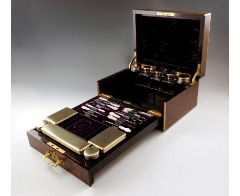 A Victorian silver-gilt mounted travelling toilet set, by George Brace, London 1866, retailed by Howell, James and Co., Regen