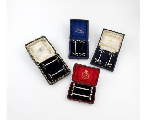Four cased pairs of silver knife rests, comprising: a pair by the Goldsmiths and Silversmiths Company, London 1923, pierced t