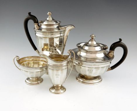 A four-piece silver tea set, by Roberts and Belk, Sheffield 1915, panelled tapering circular form, scroll handles, gadroon bo