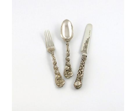A three-piece Victorian silver pierced Vine pattern knife, fork and spoon, by George Adams, London 1857, the terminals with a