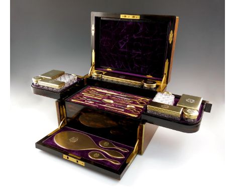 A Victorian silver-gilt mounted travelling toilet set, by William Neal, London 1870, retailed by Toulmin and Cale, New Bond S