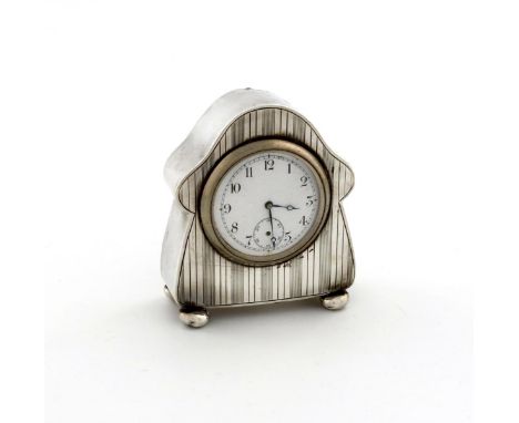A silver clock, by Charles Green and Co, Birmingham 1913, arched form, engine-turned decoration, on four bun feet, height 8.3