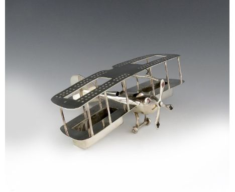 A novelty electroplated playing card holder, trump marker and cribbage board, unmarked, circa 1920, modelled as a biplane, th