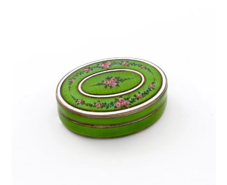 A silver-gilt and enamel box, with import marks for Birmingham 1911, oval form, decorated with flowers on a green ground with