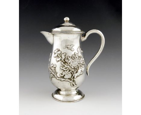 A Chinese silver hot water pot,  marked NM, and with Chinese characters, baluster form, applied blossom decoration, domed cov