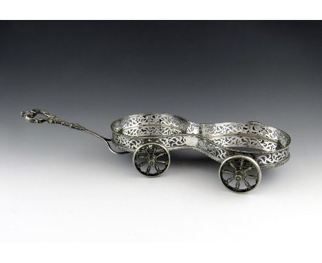 A Victorian electroplated decanter wagon, shaped oval form, pierced scroll gallery, beaded borders, foliate scroll pulling ha