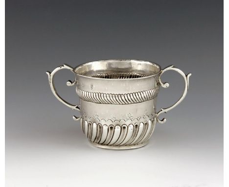 A William III two-handled silver porringer, by Thomas Ley, London 1699, circular form, scroll handles, part-fluted decoration
