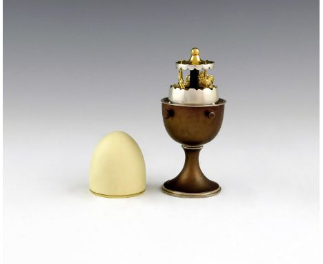 By Anthony Elson, a modern silver clockwork merry-go-round egg, London 1980, number 124 from an edition of 200, the oxidised 