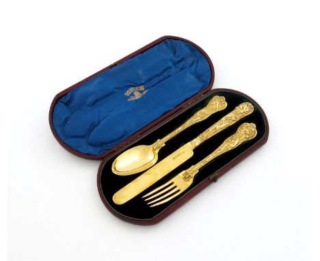 A three-piece Victorian silver-gilt Stag Hunt pattern christening set, by George Adams, London 1872, comprising: a knife, for
