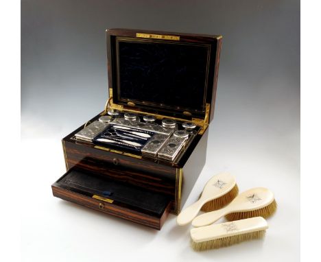 λA Victorian silver-mounted travelling toilet set, by Thomas Whitehouse, London 1868, retailed by A. Simpson and Co., 154 Reg