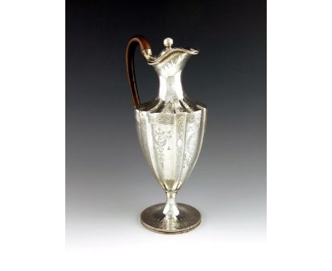 A George III silver ewer, by William Holmes, London 1787, fluted vase form, engraved decoration, scroll handle, beaded border