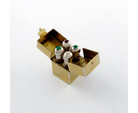 An Edwardian silver-gilt and enamel travelling scent bottle set, by William Hornby, London 1907, rectangular form, the hinged