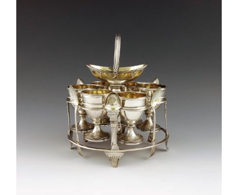 A George III silver six egg cup cruet frame, by John Emes, London 1806, oval form, wire-work frame, fluted column supports, w