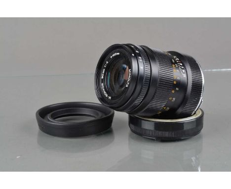 A Minolta M-Rokkor 90mm f/4 Lens, CLE/M mount, serial no 2015011, barrel G-VG, elements G-VG, with Leitz rear cap and lens ho