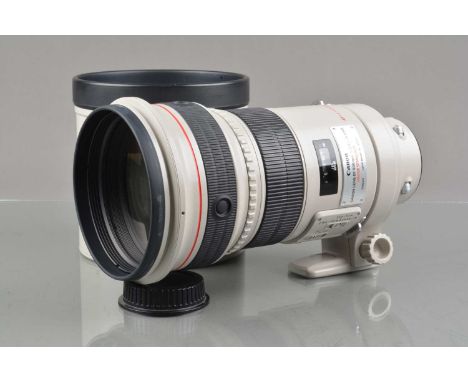 A Canon EF 300mm f/2.8 L IS USM Lens, serial no 49436, auto focus working, barrel G-VG, light fading to grip, elements VG-E, 