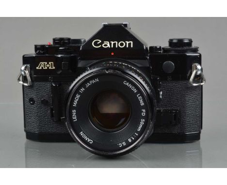 A Canon A-1 SLR Camera, black, serial no 142491, shutter working, meter responsive, self timer working, body G, some paint we