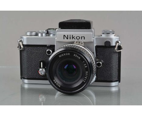 A Nikon F2 SLR Camera, chrome, serial no 8024634, shutter working, self timer working, body G-VG, light wear, with DW-1 waist