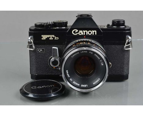 A Canon FTb QL SLR Camera, black, serial no 399738, shutter working, meter responsive, self timer working, body G, some paint