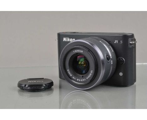 A Nikon 1 J1 Digital Camera,  black, shutter working, flash working, appears to function as should, body VG, with 1 Nikkor 10